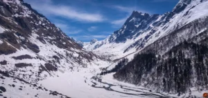 Trekkers ascending steep snow slopes.