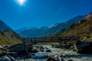 Wooden bridge over rapids.